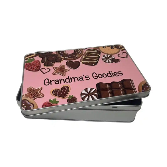Tin box with 'Grandma's Goodies' text and biscuit pictures on a pink background